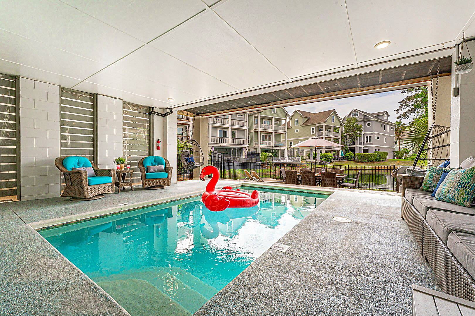 Heated private pool beneath 122 Sandcastle Court with the open to the lagoon and neighbouring houses beyond